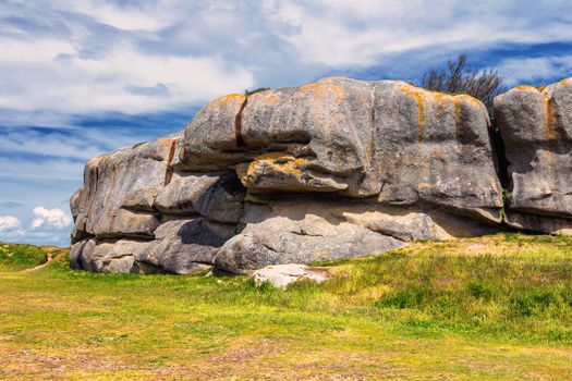 The pink granite rocks with strange shapes, coast in Brittany. The mass of enormous pink rocks, the pink granite, rock with strange shapes. Brittany (Bretagne), France