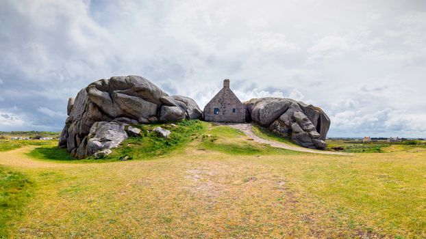 House between the rocks in Meneham village, Kerlouan, Finistere, Brittany (Bretagne), France
