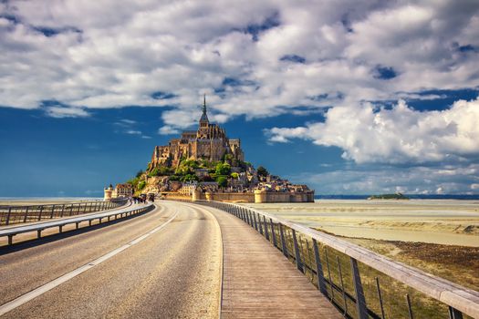 Beautiful panoramic view of famous Le Mont Saint-Michel tidal island with blue sky. Normandy, northern France
