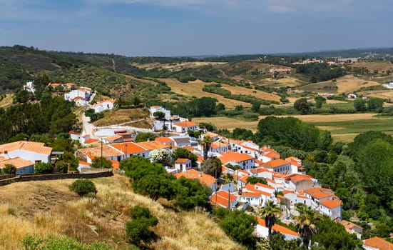 Charming architecture of hilly Aljezur, Algarve, Portugal. View to the small town of Aljezur with traditional portuguese houses and rural landscape, Algarve, Portugal.