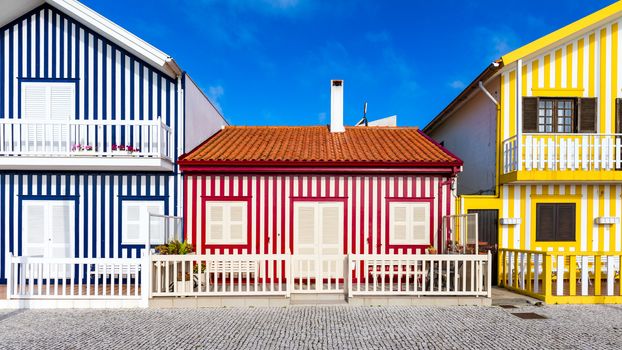 Street with colorful houses in Costa Nova, Aveiro, Portugal. Street with striped houses, Costa Nova, Aveiro, Portugal. Facades of colorful houses in Costa Nova, Aveiro, Portugal.