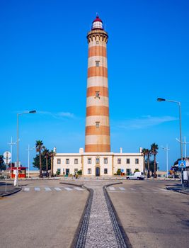 Lighthouse of Praia da Barra during the day, with a clear blue sky. View of the lighthouse of Barra beach (Praia da Barra) in Aveiro, Portugal. 