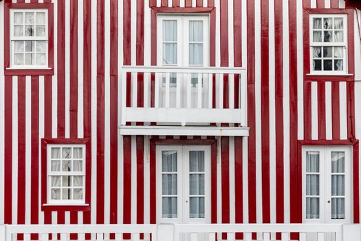 Colored Windows of "Costa Nova do Prado", Portugal. Windows in typical small wooden house with colorful stripes in Costa Nova. Aveiro. Portugal. Detail of the house in famous resort Costa Nova.