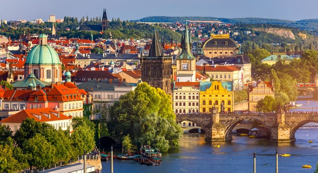 Scenic view of the Old Town pier architecture and Charles Bridge over Vltava river in Prague, Czech Republic. Prague iconic Charles Bridge (Karluv Most) and Old Town Bridge Tower at sunset, Czechia.