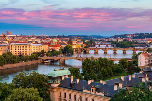 Scenic view of the Old Town pier architecture and Charles Bridge over Vltava river in Prague, Czech Republic. Prague iconic Charles Bridge (Karluv Most) and Old Town Bridge Tower at sunset, Czechia.