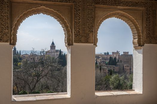 Nice arch windows in ancient Arabian palace Alhambra. Granada, Spain. Islamic architecture