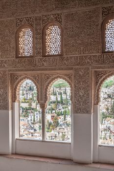 Nice arch windows in ancient Arabian palace Alhambra. Granada, Spain.