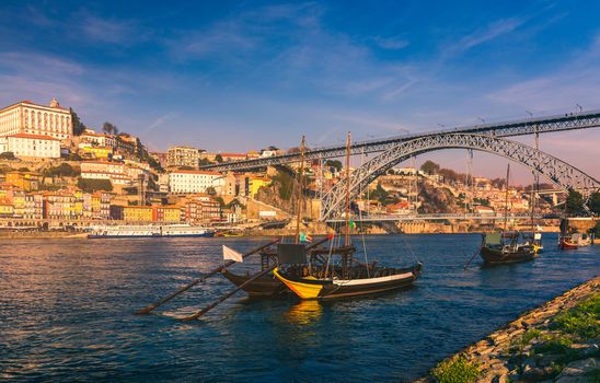 Oporto or Porto city skyline, Douro river, traditional boats and Dom Luis or Luiz iron bridge. Porto, Portugal, Europe.