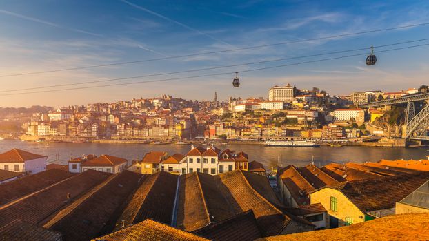 Porto (Oporto), old town on the Douro River, panorama of Porto with cable cars and boats. Porto, Portugal.