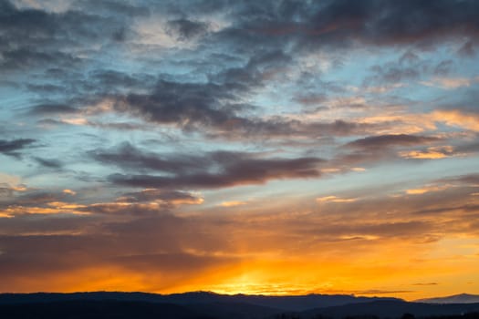 Natural Sunset Sunrise Over Field Or Meadow. Bright Dramatic Sky And Dark Ground. Countryside Landscape Under Scenic Colorful Sky At Sunset Dawn Sunrise. Sun Over Skyline, Horizon. Warm Colours.