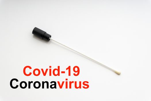 COVID-19 CORONAVIRUS text with medical swab on white background. Covid or Coronavirus Concept 