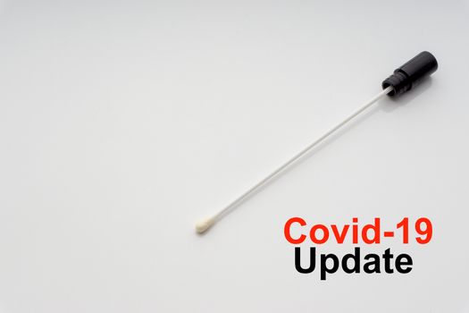 COVID-19 UPDATE text with medical swab on white background. Covid or Coronavirus Concept 