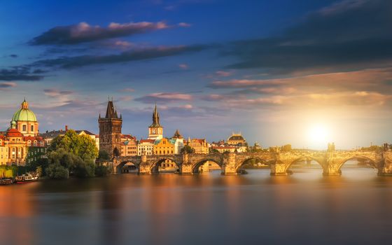 Prague, Czech Republic panorama with historic Charles Bridge and Vltava river on sunny day.