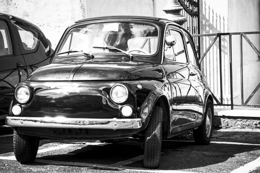 Vintage 500 FIAT on the street of Rome. Street view from the old city of Rome. Vintage vehicle parked on the street of Rome. Black and white image