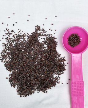 Top view of mustard seeds in a bowl kept for drying before cooking