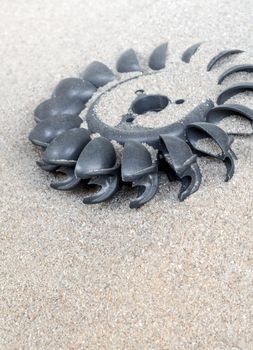 Old water turbine on dried sand without water, useless in drought condition