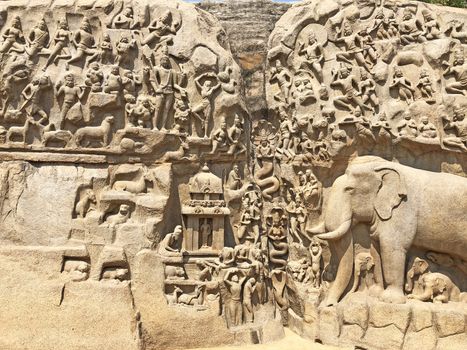 A giant open air rock cut bas relief sculptures carved on two monolithic rocks in Mahabalipuram, Tamil nadu. It contains sculptures of animals, God, People and half-humans.