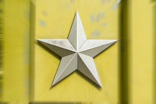 silver metal five pointed Soviet star on a blurred background of light greenish yellow color