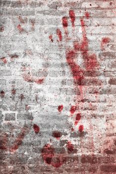 Bloody handprints and blotches of blood on grunge wall. Background for spooky content, halloween and more.