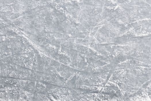 Details of an ice skating rink, with marks and scratches of skate blades.