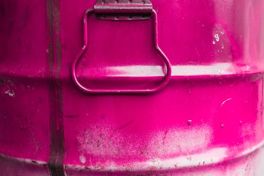 Extreme close up of a tin of pink paint.