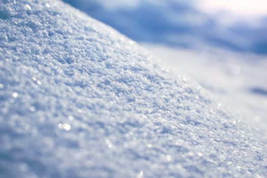 Macro background of fresh snowflake texture on a blur.