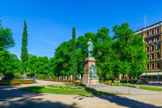 HELSINKI, FINLAND - JUNE 16, 2017: View of the Esplanade Park and the Runeberg Statue, with locals and visitors, in Helsinki, Finland