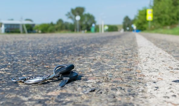 Lost a bunch of keys lying on the asphalt surface of the roadway