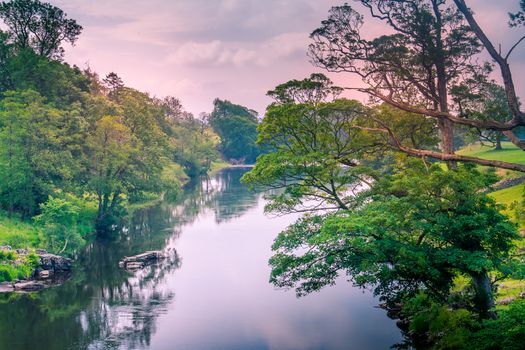 Sunlight colors the river Lune taken from bridge near Kirkby Lonsdale