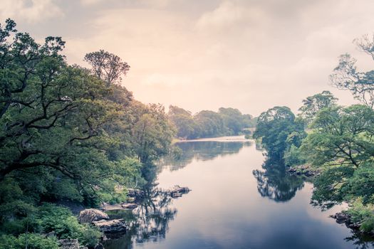 Sunlight colors the river Lune taken from bridge near Kirkby Lonsdale