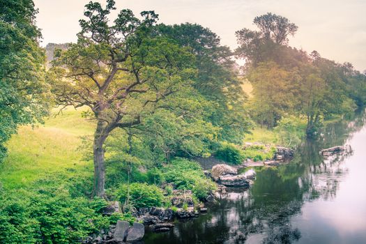 Sunlight colors the river Lune taken from bridge near Kirkby Lonsdale