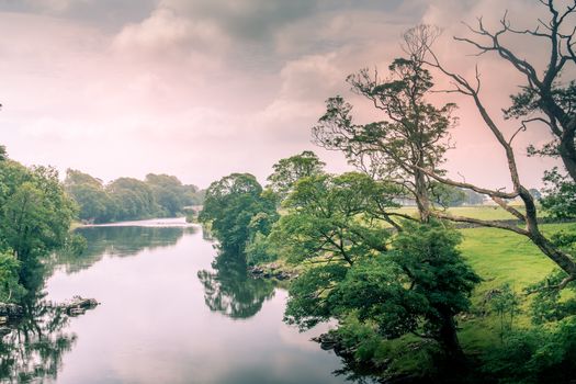 Sunlight colors the river Lune taken from bridge near Kirkby Lonsdale