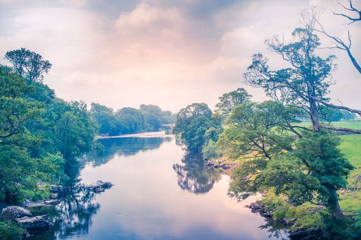 Sunlight colors the river Lune taken from bridge near Kirkby Lonsdale