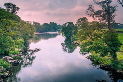 Sunlight colors the river Lune taken from bridge near Kirkby Lonsdale