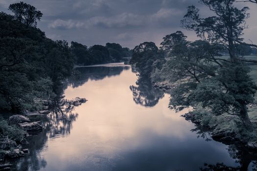 Sunlight colors the river Lune taken from bridge near Kirkby Lonsdale