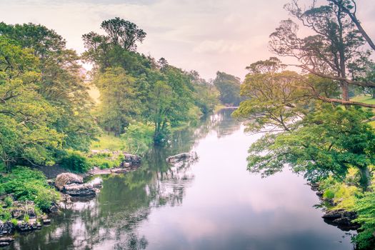 Sunlight colors the river Lune taken from bridge near Kirkby Lonsdale