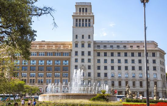 BARCELONA, SPAIN - JULY 5, 2016: View of Square of Catalonia (Placa de Catalunya) in Barcelona, Spain.

Barcelona, Spain - July 5, 2016:  View of Square of Catalonia (Placa de Catalunya) in Barcelona, Spain. Placa Catalunya is one of the most popular areas of Barcelona. It is located between the old town and the Eixample district. From Plaza Catalunya originate two most famous streets of Barcelona - Paseo Gracia and Rambla. People are walking by square.