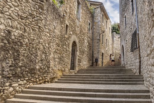 GIRONA, SPAIN - JULY 6, 2016: Ancient medieval street in Girona, Catalonia, Spain

Girona, Spain - July 6, 2016: Ancient medieval street in Girona, Catalonia, Spain. People are walking by street.