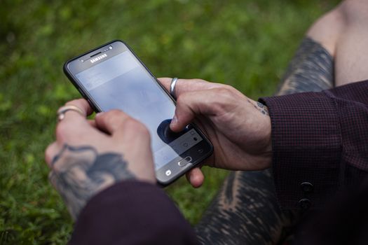 BOLOGNA, ITALY 17 JUNE 2020: Hands hold smartphone