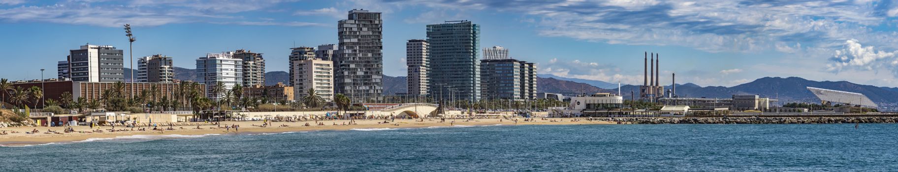 BARCELONA, SPAIN - JULY 13, 2016: Panoramic view of Sant Marti district, Barcelona, Spain

Barcelona, Spain - July 13, 2016: Panoramic view of Sant Marti district, Barcelona, Spain. People are resting on the beach.