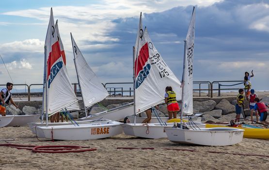 BARCELONA, SPAIN - JULY 13, 2016: People prepare yachts for surfing. Municipal Nautical Barcelona - surfing club for children and adult. Located in Park Poblenou, Barcelona, Spain.

Barcelona, Spain - July 13, 2016: People prepare yachts for surfing. Municipal Nautical Barcelona - surfing club for children and adult. Located in Park Poblenou, Barcelona, Spain.