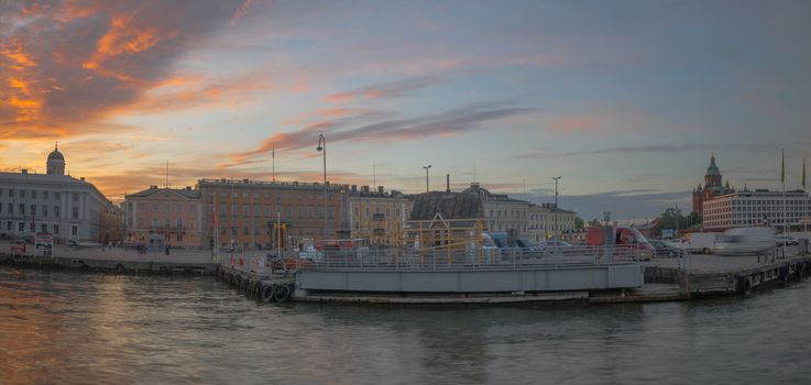 HELSINKI, FINLAND - JUNE 16, 2017: Sunset view of the south harbor, with locals and visitors, in Helsinki, Finland