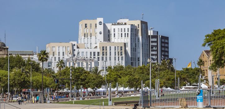 BARCELONA, SPAIN - JULY 4, 2016: New modern architecture in Port Vell district.

Barcelona, Spain - July 4, 2016: New modern architecture in Port Vell district. People are walking by street.