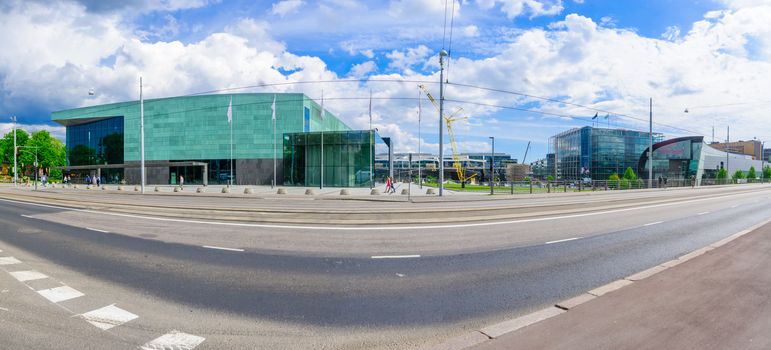 HELSINKI, FINLAND - JUNE 17, 2017: View of the Helsinki Music Center (Musiikkitalo), and the Museum of Contemporary Art (Kiasma), with locals and visitors, in Helsinki, Finland