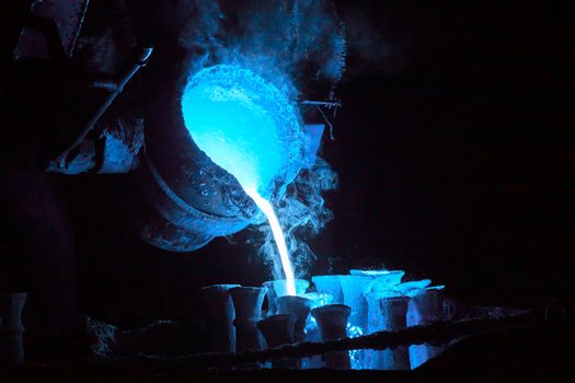 steel casting process toned blue for magic potion or chemical or biohazard or radioactive waste illustration.