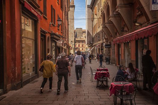 BOLOGNA, ITALY 17 JUNE 2020: Alley of the city of Bologna in Italy with people walking