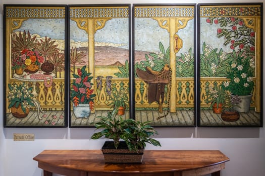 Waimea, Hawaii, USA. - January 15, 2020: Parker Ranch headquarters. 4 panel polyptych painting of colorview view out of window, hung inside historic office.