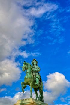 Versailles, France - April 24, 2019: Louis XIV statue just outside of the gates of Versailles Palace on a sunny day outside of Paris, France.