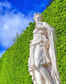 Versailles, France - April 24, 2019: The statues and fountains in and around the garden of Versailles Palace on a sunny day outside of Paris, France.