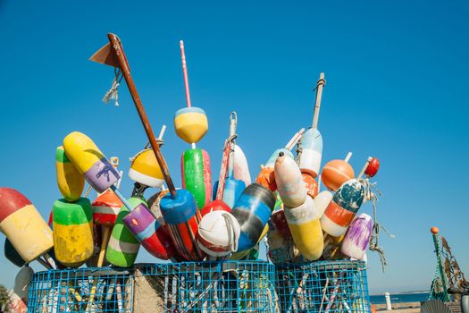Collection of colorful fishing or lobster trap buoys and markers at wharf in Provincetown, Massachusetts, USA.